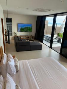 a living room with a bed and a couch at Villa Miario in Koh Samui +37 photos