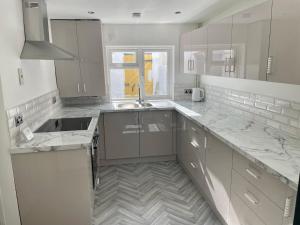 a kitchen with marble counter tops and a sink at Town Centre En Suite Room 1 in Barnstaple +17 photos