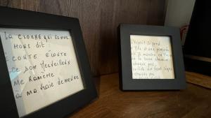 two framed photographs with writing on them on a table at Charmant T2 en coeur de ville 15min de Disney in Lagny +11 photos