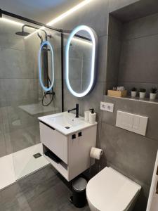 ÁngelesにあるApartamento Porta de Fisterraの白い洗面台と鏡のあるバスルーム +10枚の写真