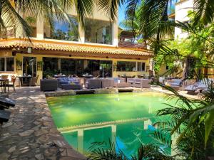 a swimming pool in front of a house at La Villa Boutique Hotel in Accra