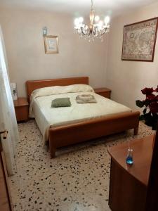 a bedroom with a bed and a chandelier at CASA di PIERO in Monte San Pietrangeli