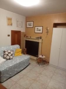 a living room with a couch and a fireplace at CASA di PIERO in Monte San Pietrangeli