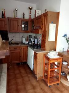 a kitchen with wooden cabinets and a stove top oven at CASA di PIERO in Monte San Pietrangeli