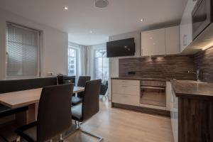 a kitchen with a table and chairs and a stove at Petit Madlein in Ischgl