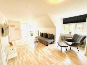 a living room with a couch and a chair at aday - Gorgeous 1 bedroom apartment in Randers in Randers