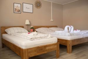 two beds in a room with towels on them at Kuzey Apartments in Kappel-Grafenhausen