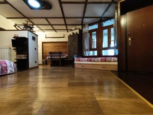 a large room with two beds and a wooden floor at Cuckoo Apartment in Pila