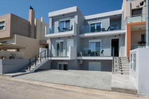 a large apartment building with a large driveway at Santa Marina Luxury Apartments #1 with pool in Asgourou