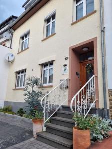 a house with stairs leading up to a door at Georgs Ferienhaus in Zeltingen-Rachtig