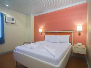 Ένα ή περισσότερα κρεβάτια σε δωμάτιο στο WinMin Transient Inn