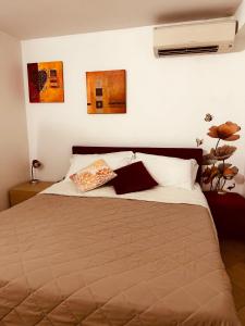 a bedroom with a large bed with two pillows at Hotel Agathae in Catania +34 photos