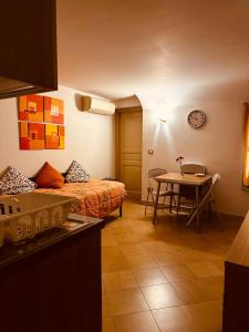 a room with a bed and a table and a kitchen at Hotel Agathae in Catania