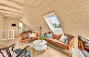 a living room with a couch and a table at Four-Bedroom Holiday Home In Skjern in Skjern