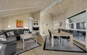 a living room with a table and a couch at Holiday Home Krogen Ringkøbing in Søndervig