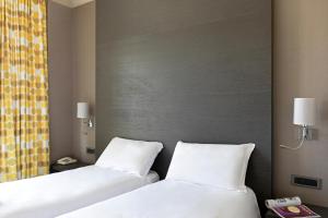 Кровать или кровати в номере B&B Hotel Savona