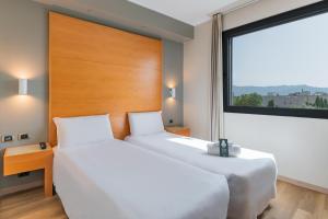 Postel nebo postele na pokoji v ubytování B&B HOTEL Pisa Airport