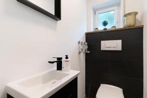 a bathroom with a sink and a toilet at Lopezan home and living in Hornberg +15 photos