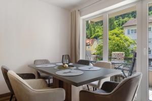 a dining room with a table and chairs and a window at Lopezan home and living in Hornberg
