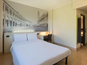 Postel nebo postele na pokoji v ubytování B&B Hotel Faenza