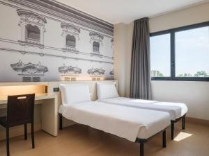 Postel nebo postele na pokoji v ubytování B&B Hotel Faenza