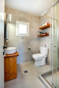 a bathroom with a toilet and a sink and a shower at Efi's House in Kallirákhi +31 photos