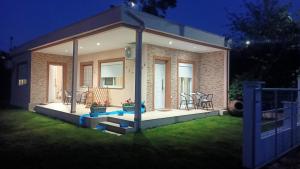 a small house with chairs and tables in a yard at Bright Sea - Studios in Limenas