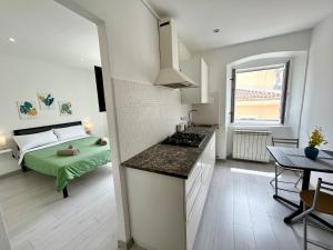 a kitchen and a bedroom with a bed and a table at Residence Zar 7 in Trieste