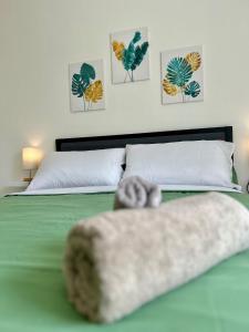 a bedroom with a bed with a towel on it at Residence Zar 7 in Trieste +9 photos