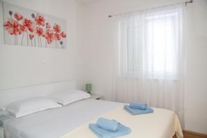 a white bedroom with two towels on a bed at Villa Macanovi dvori with private pool in Knežević +44 photos