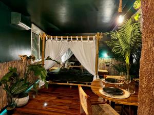 a dining room with a table and a bed in a room at Jungle Love Room in Toulouse