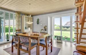 a kitchen with a dining room table and chairs at Holiday Home Strandvænget Bogense Denm in Bogense