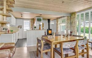 a kitchen and dining room with a table and chairs at Holiday Home Strandvænget Bogense Denm in Bogense