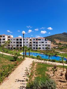 a resort with a swimming pool and buildings at Cabo Negro-Lilac's Garden in Cabo Negro