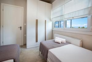 a bedroom with a bed and a window at Efi's House in Kallirákhi