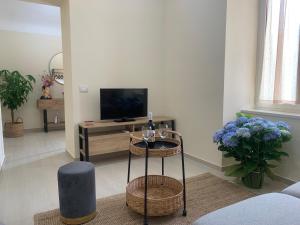 a living room with a television and a table at La Primavera Apartment in Ercolano