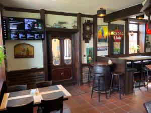 a bar in a restaurant with tables and chairs at Landgasthof zum Hasen in Meerbusch