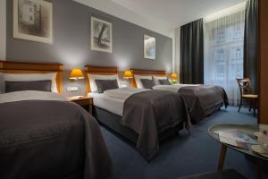 Postel nebo postele na pokoji v ubytování Prague Season Hotel