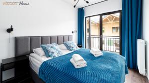 Posteľ alebo postele v izbe v ubytovaní Wonder Home - Apartamenty Karpatia Resort tuż przy stoku i blisko szlaków turystycznych