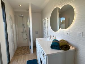 a bathroom with a sink and a mirror at Appartement neuf T2 avec jardin et terrasses in Arcachon +8 photos