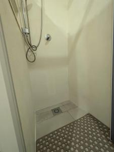 a bathroom with a shower with a tile floor at Casa Antico Forno in Manciano +12 photos