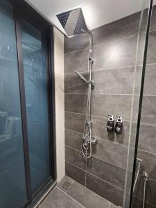 a bathroom with a shower with a glass door at Summer Cozy 2pax Netflix Almas Suite Legoland at Iskandar Puteri Second Link Custom in Nusajaya