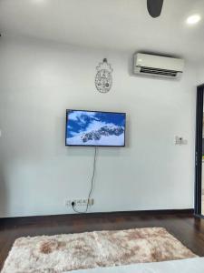 a white wall with a tv and a clock on it at Summer Cozy 2pax Netflix Almas Suite Legoland at Iskandar Puteri Second Link Custom in Nusajaya