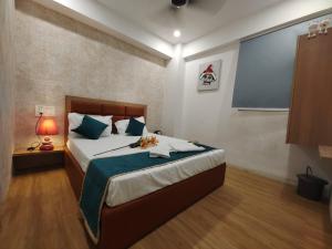 a bedroom with a bed and a large screen at Hotel PRASANG in Surat