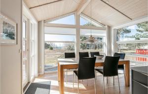 Un comedor con mesa y sillas en Holiday Home Aakirkeby With Fireplace 02, en Vester Sømarken