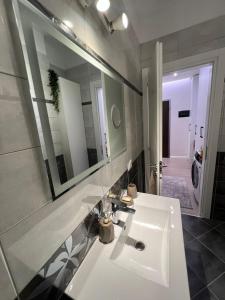 a bathroom with a white sink and a mirror at Gold Vollga House Durres in Durrës +28 photos
