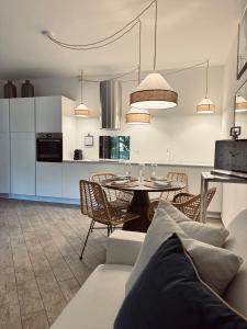 a living room and kitchen with a table and chairs at Villa Marina in Marina dʼAndora