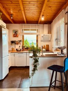 eine Küche mit weißen Schränken und einer Holzdecke in der Unterkunft Żuławska Osada in Trutnowy