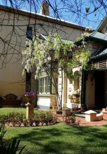 a house with a garden in front of it at Water Bay Villa Bed & Breakfast in Adelaide