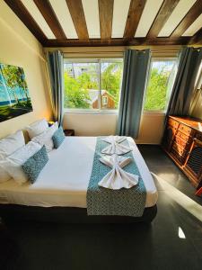 Postel nebo postele na pokoji v ubytování Hôtel Coco Island